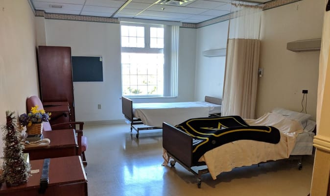 Private resident room with two beds and seating