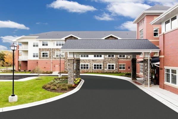 Exterior view of a senior living facility with landscaped gardens