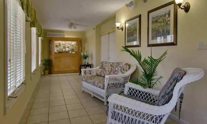 Lounge area with wicker furniture and framed artwork
