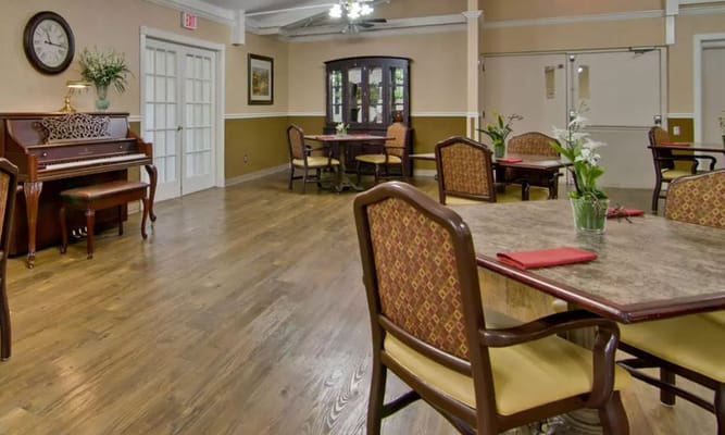 Cozy dining area with tables, chairs, and a piano