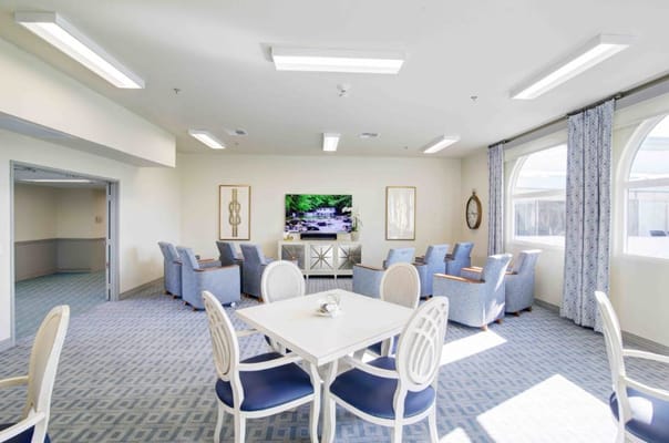 Bright and inviting common area with seating and a large TV