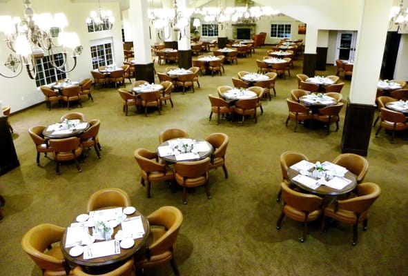 Spacious dining area with round tables and seating
