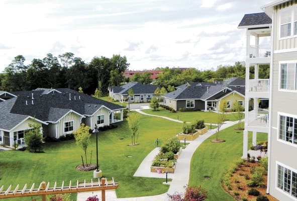 Bird's eye view of Colonial Gardens with landscaped grounds and residential buildings.