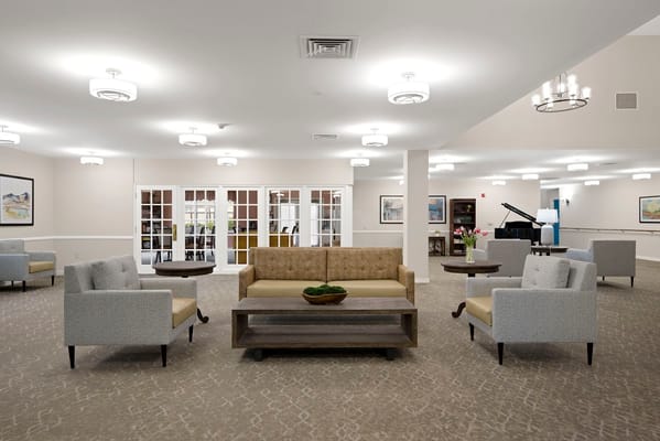 Bright common area with seating and piano