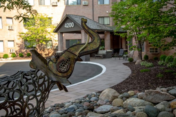 Outdoor courtyard with a sculpture and building entrance