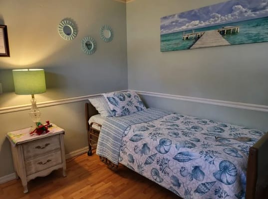 Cozy bedroom with a bed, lamp, and decorative wall art