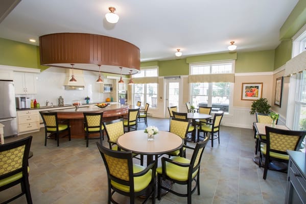 Modern kitchen dining area with green accents and round tables