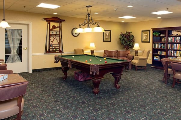 Interior common area with a billiard table and seating