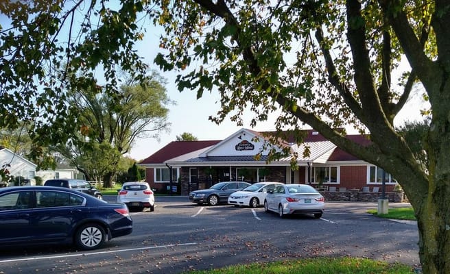 Exterior view of Country Rest Home facility with parking