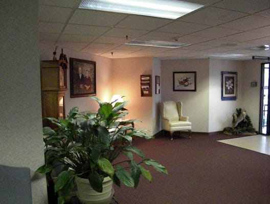Interior view of a common area, decorated with plants and artwork