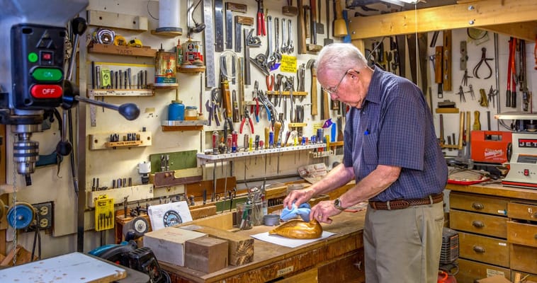 An elderly man working in a workshop