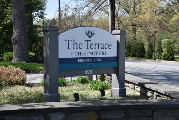 Sign for The Terrace At Chestnut Hill indicating senior living services