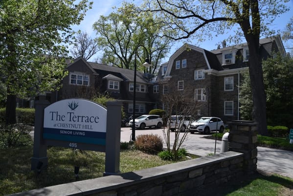 Exterior view of The Terrace At Chestnut Hill with sign in front