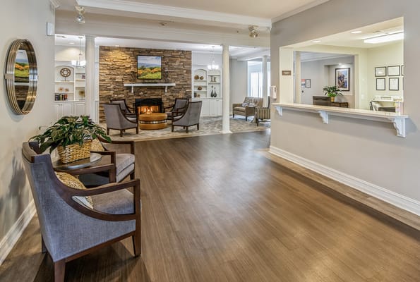 Cozy lobby area with comfortable seating and a stone fireplace