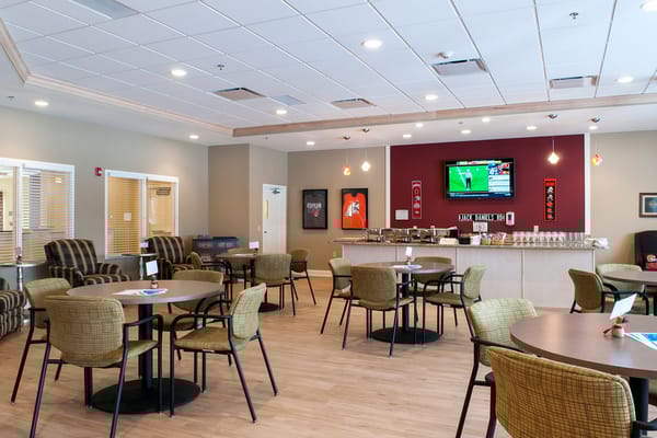 Interior view of the dining room with tables and a television.