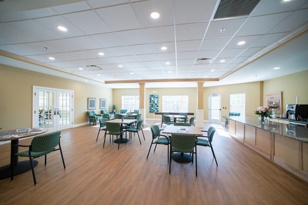 Bright and spacious common area with seating and tables