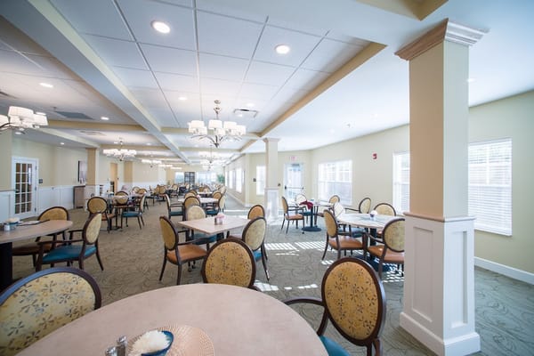 Bright dining area with tables and chairs at Danbury Mount Vernon