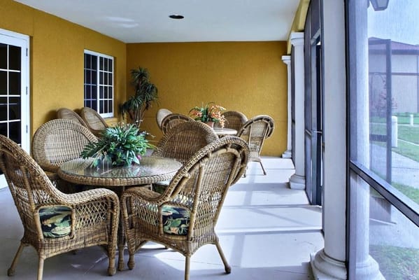 Outdoor seating area with wicker chairs and tables