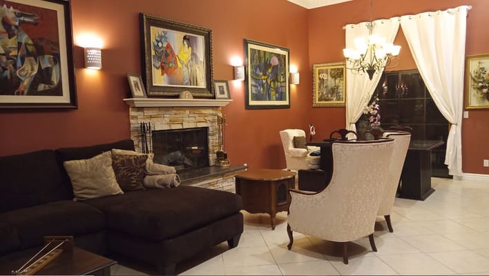 Spacious living room with artwork, fireplace, and comfortable seating