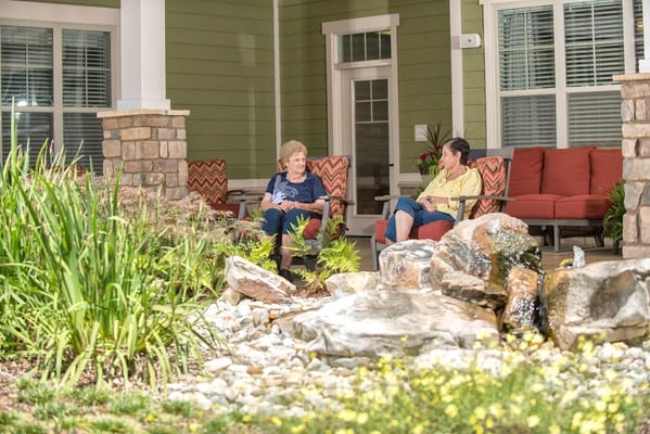 Residents enjoying the outdoor area with a garden