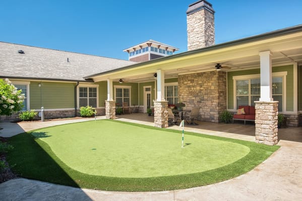 Outdoor area with landscaped green space and seating