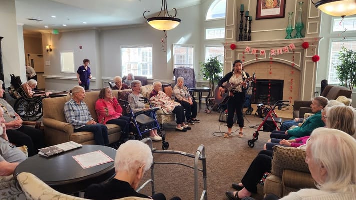 Residents enjoying a live music performance in the common area