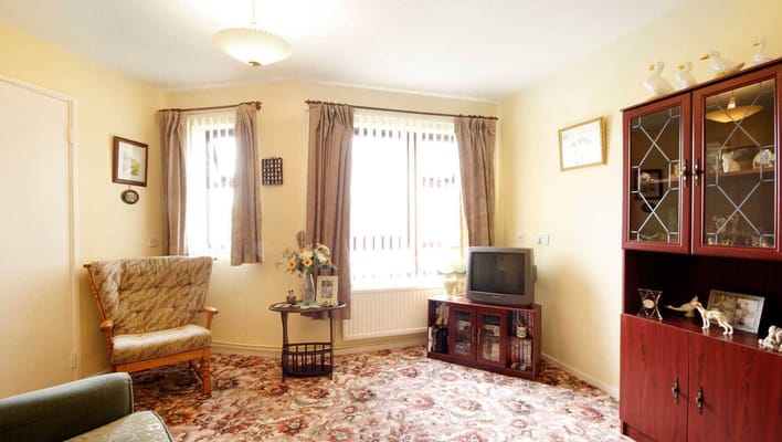 Living room with a comfortable seating area and decorative furnishings.