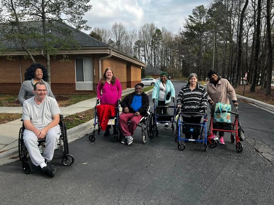Group of residents in wheelchairs and walkers at East Towne.
