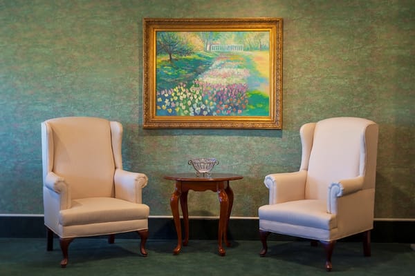 Interior seating area with armchairs and artwork