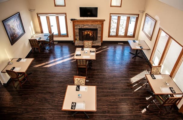 Bright dining room with tables and a fireplace