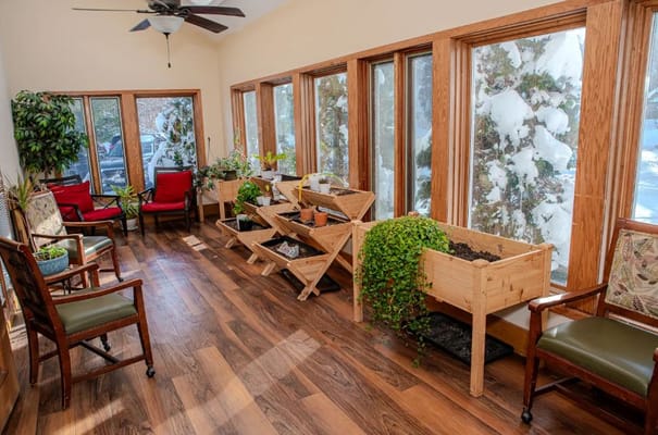 Bright interior space with plants and seating by windows