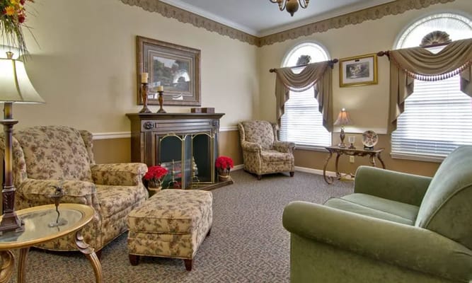Comfortable living room with floral armchairs and a fireplace