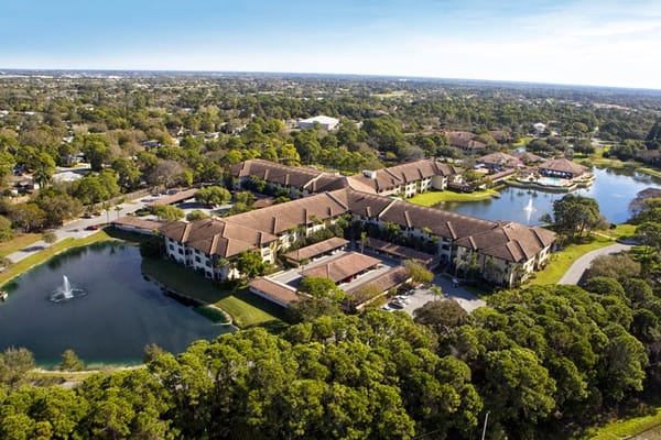 Aerial view of Elancé at Sarasota with lush greenery and water features.