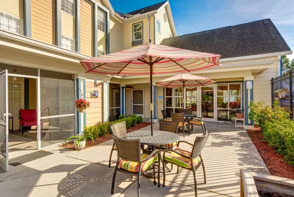 Outdoor seating area with tables and umbrellas