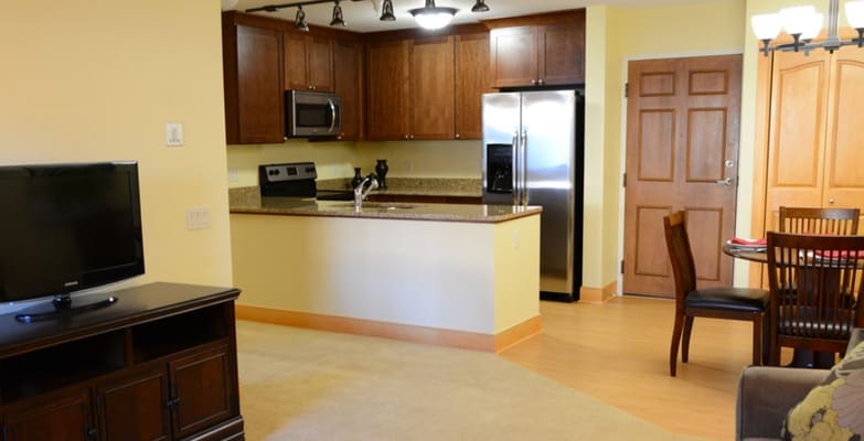 Interior view of a senior living apartment kitchen and dining area