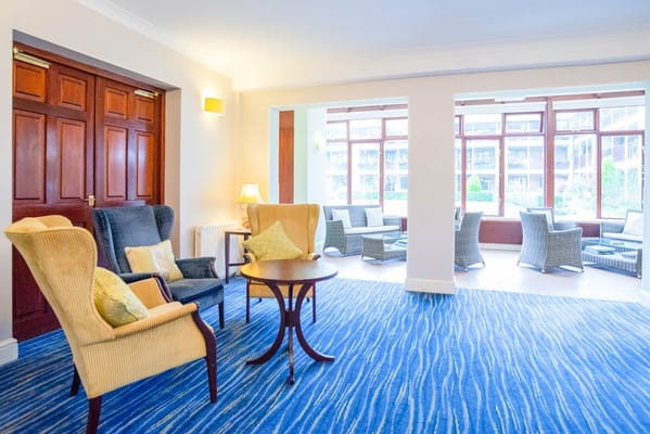 Bright common area with seating and large windows