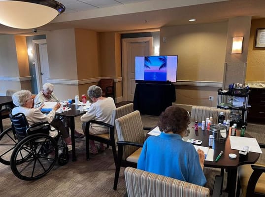 Residents engaging in an art activity in a common area