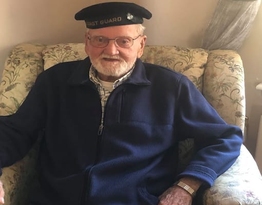 Smiling resident in a cozy armchair