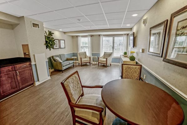 Bright communal lounge area with seating and natural light