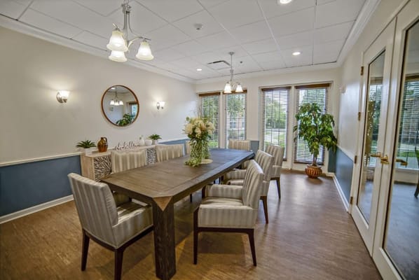 Bright common area with a dining table and chairs
