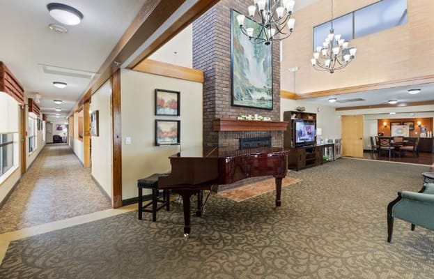 Spacious lobby featuring a grand piano and artwork