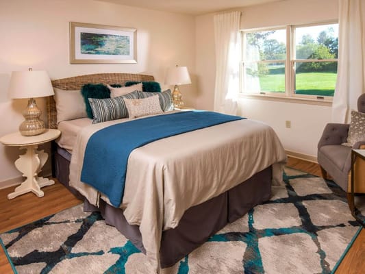 Cozy interior of a resident room with a bed and chair