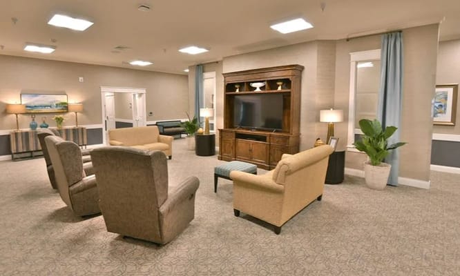 Lounge with seating area and TV in Field Pointe Assisted Living