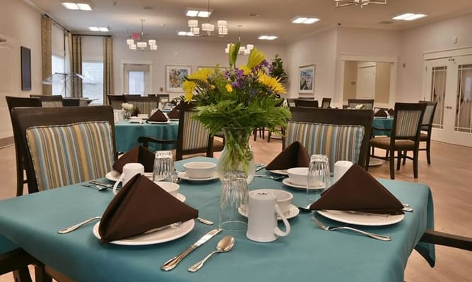 Set dining table in the dining room with flower centerpiece