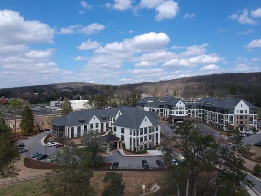 Aerial view of a senior living facility surrounded by trees