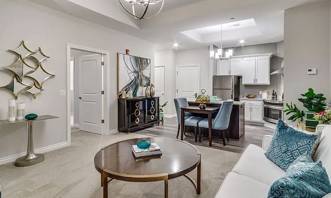 Spacious living room with dining area and kitchen in Flourish Collection.