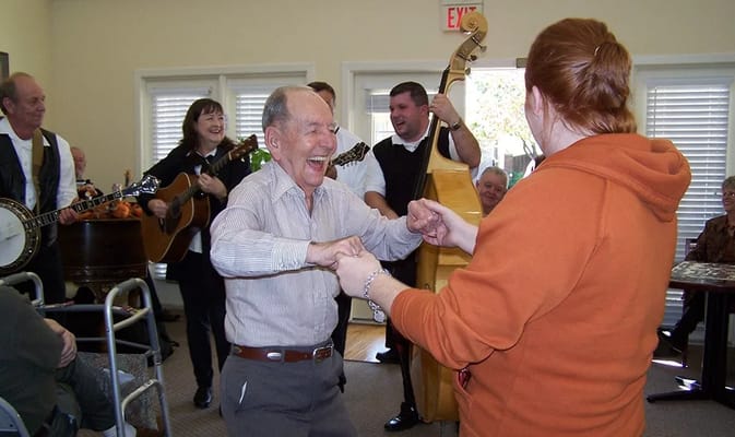 Residents enjoying a musical performance in the common area