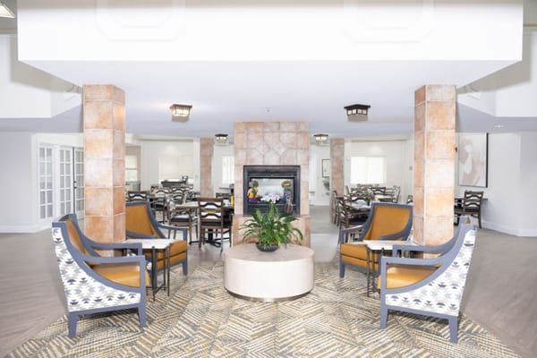 Living room with seating and fireplace in Foothill Village