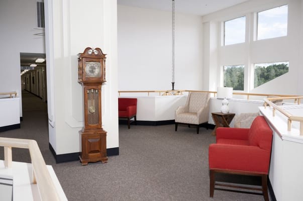 Lobby area featuring comfortable seating and a grandfather clock