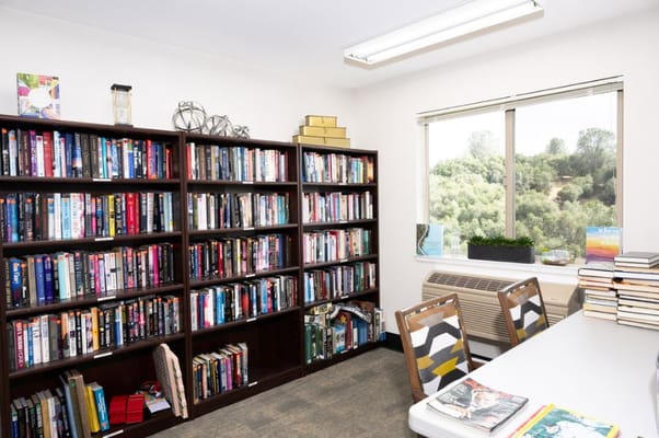 Interior view of the library with bookshelves and a table